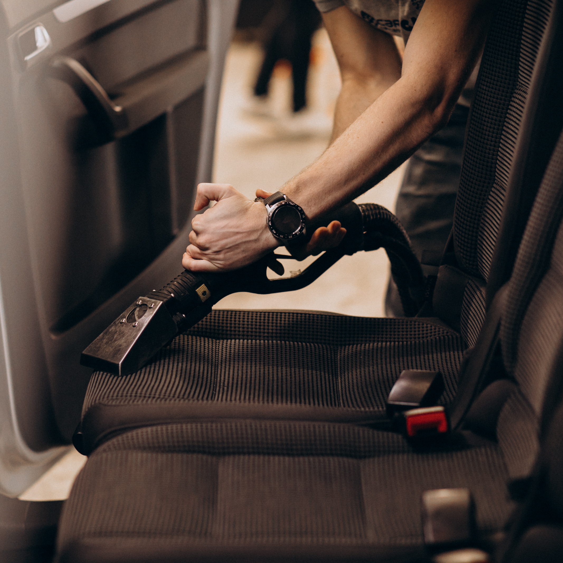 Auto detailing professional in RGV expertly extracting and deep cleaning vehicle seats for a like new interior finish.